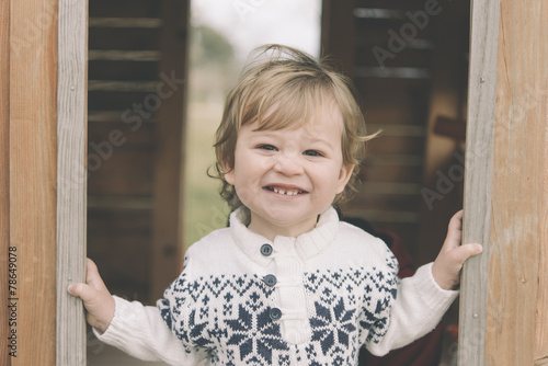 cute baby boy playing in tree house, outdoor