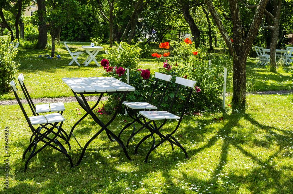 Garden furniture in a verdant park in Sweden. Garden furniture in a verdant park in Sweden.