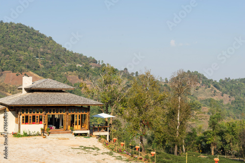 Wooden building on hill with mountain view