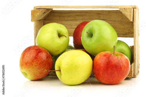 Wall Mural assorted fresh apples in a wooden crate on a white background