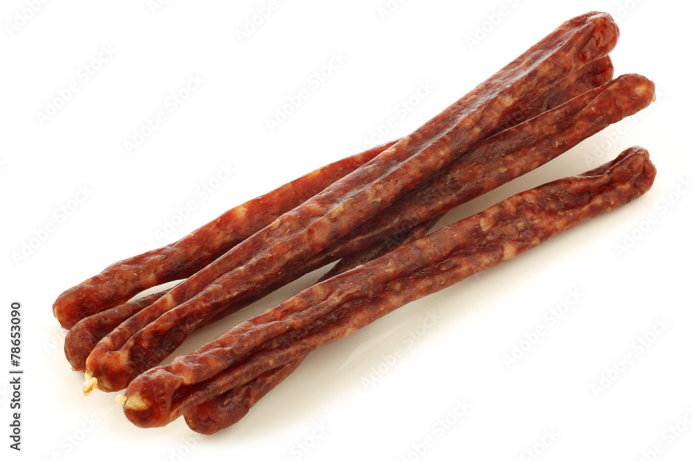 traditional frisian dried sausage sticks on a white background traditional frisian dried sausage sticks on a white background