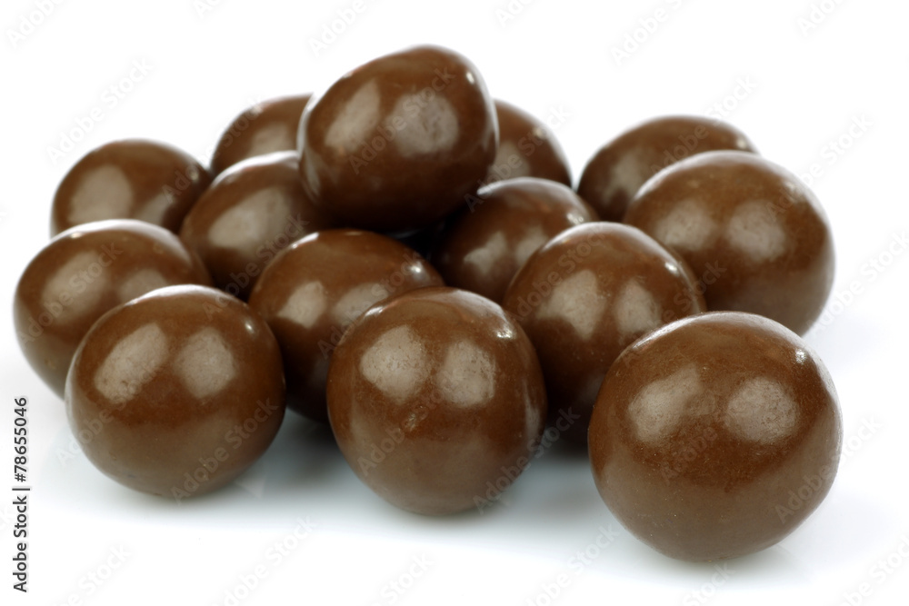 Fototapeta premium chocolate balls filled with hazelnuts on a white background