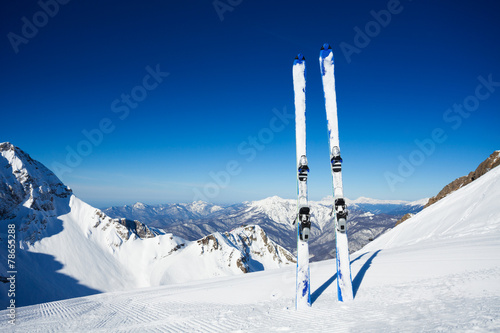 Skies in snow over mountain pistes panorama © Sergey Novikov