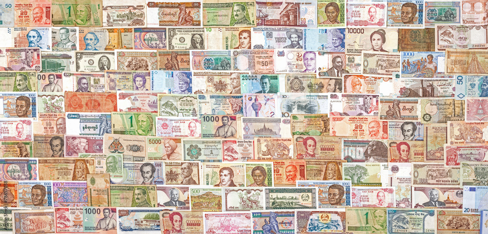 Banknotes from all over the world overlapping each other.