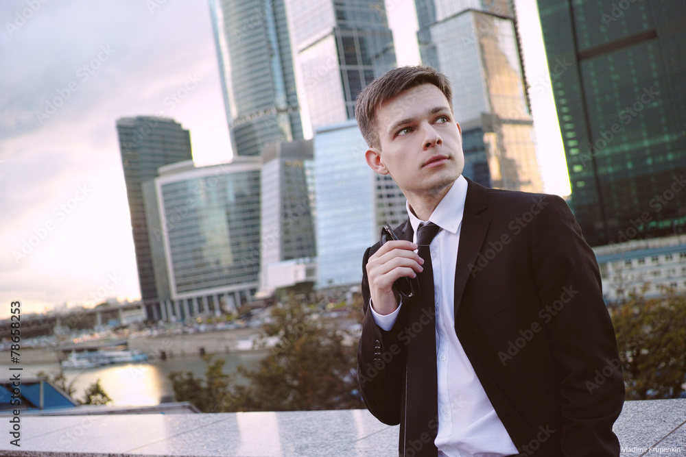 Businessman on background of the business center is holding Businessman on background of the business center is holding