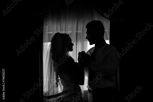 silhouette of a bride and groom in front of the window