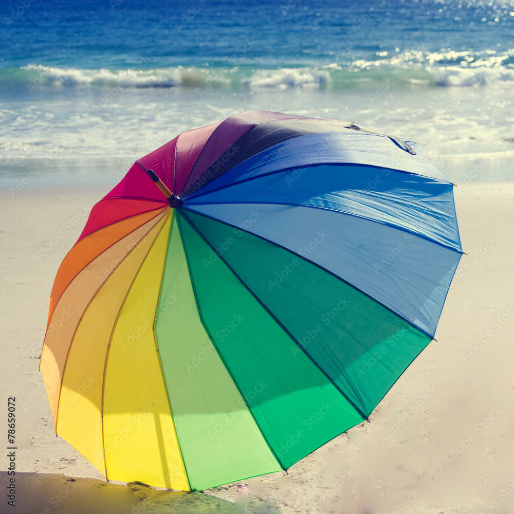 Rainbow umbrella by the ocean