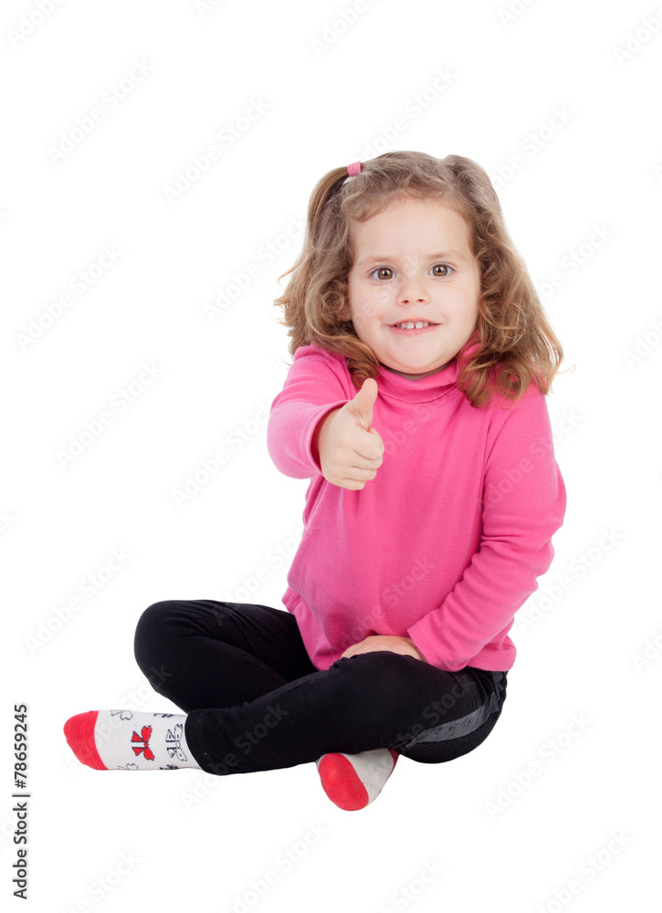 Cute little girl sitting on the floor saying Ok Cute little girl sitting on the floor saying Ok