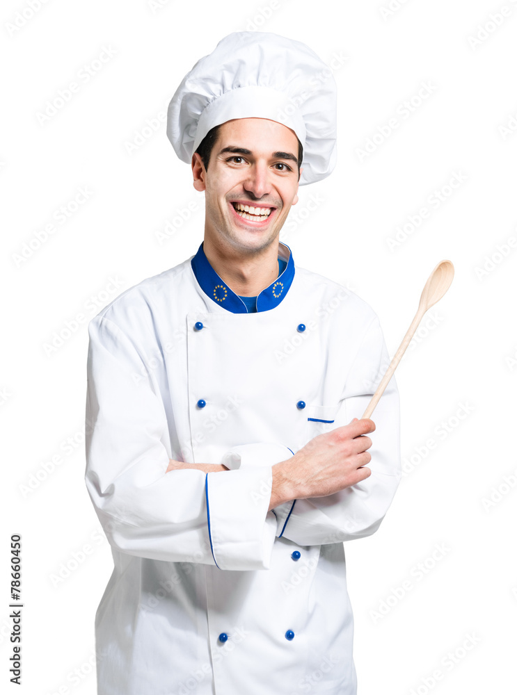 Young smiling chef isolated on white holding a spoon