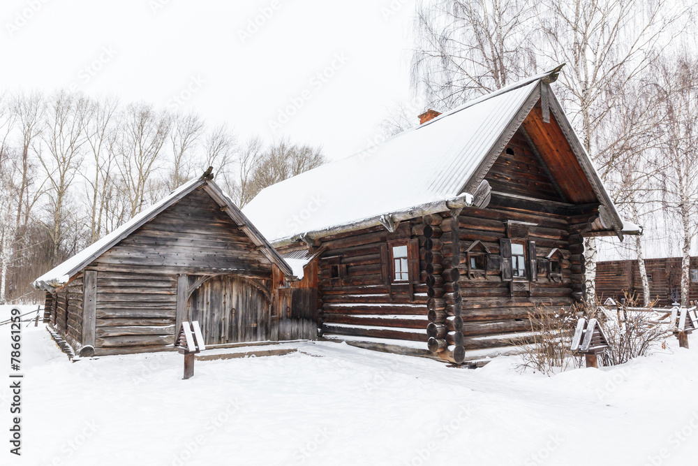 Traditional rural wooden house in winter Traditional rural wooden house in winter