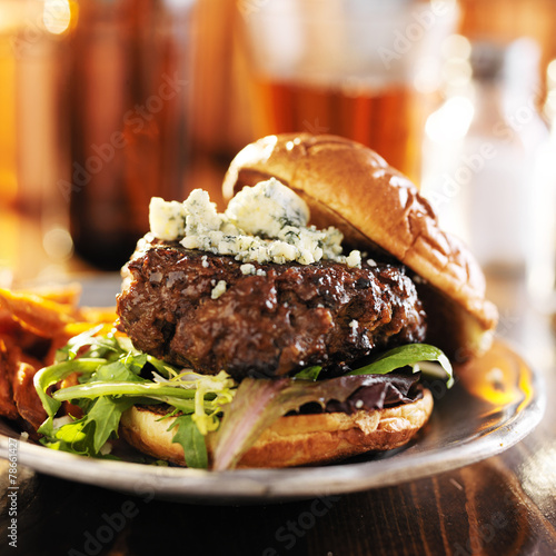gourmet hamburger with blue cheese served with beer
