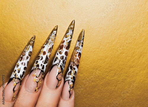 Art design  nails on gold background.