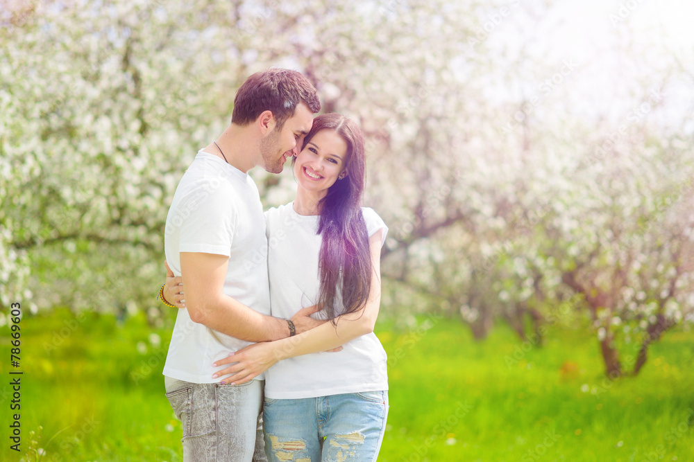 happy young couple in the garden happy young couple in the garden