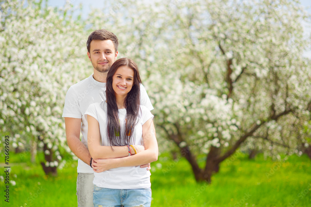happy young couple in the garden happy young couple in the garden