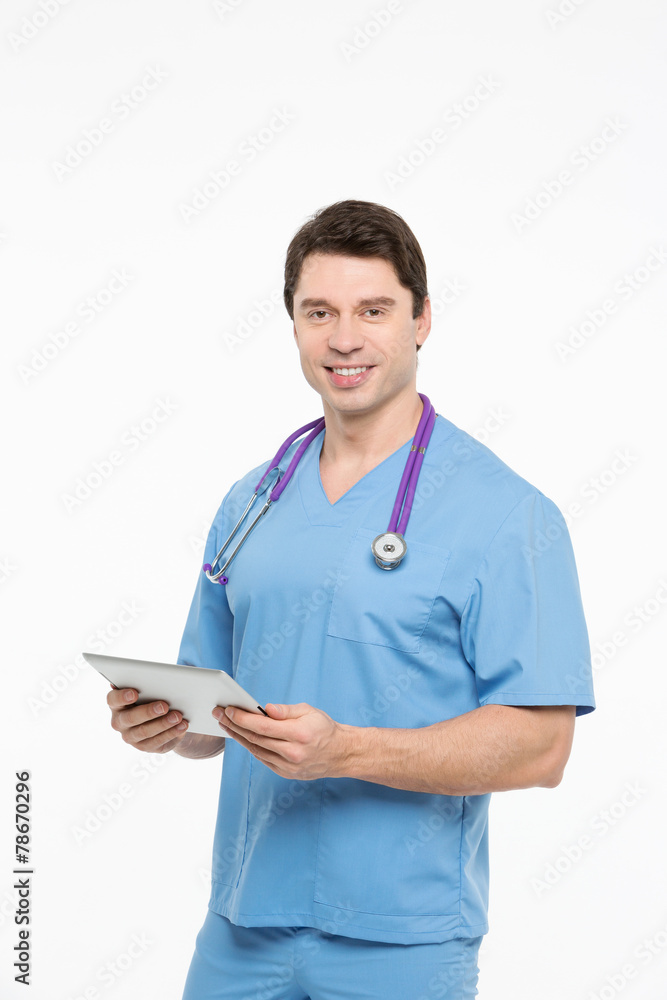 Portrait of a charming male nurse working on tablet pc Portrait of a charming male nurse working on tablet pc