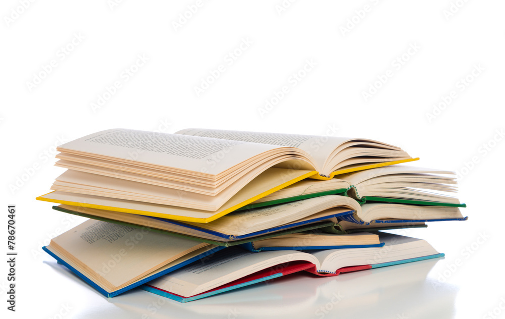 A stack of colorful, open books on a white background A stack of colorful, open books on a white background
