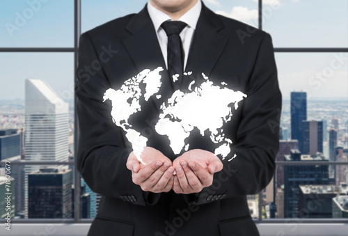 businessman holding world map photo