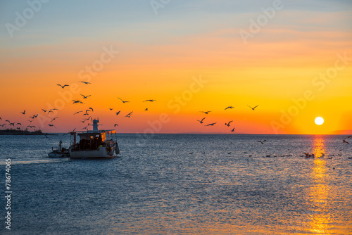 Fising boat on sunset © rh2010