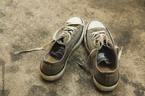 Vintage old sneakers on floor, process color, soft focus.