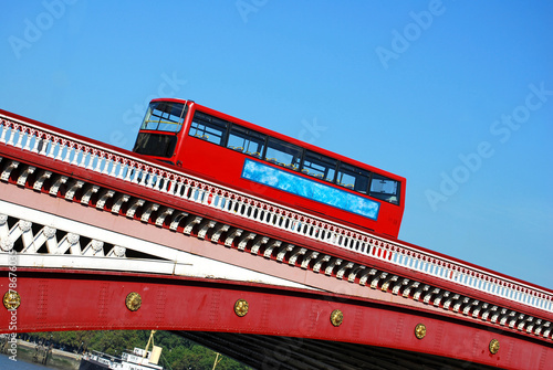 Red double decker bus on Blackfriars bridge in London photo