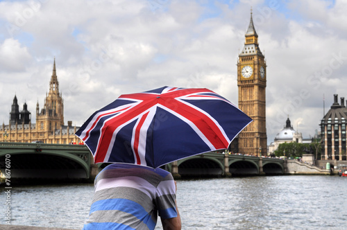 Big Ben and tourist with British flag umbrella in London