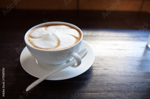 Cappuccino cup with white spoon.