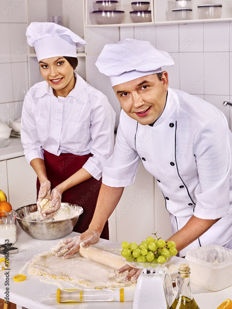 Woman man in chef hat cooking chicken. Woman man in chef hat cooking chicken.