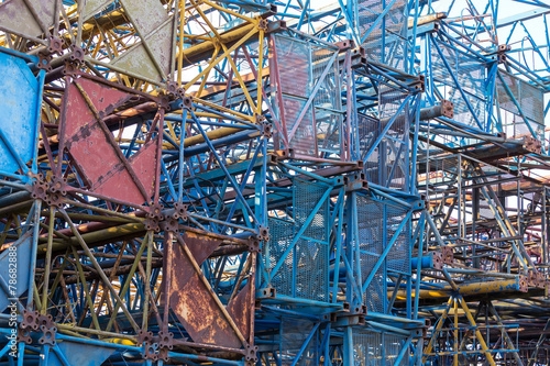 Stacked disassembled building cranes background