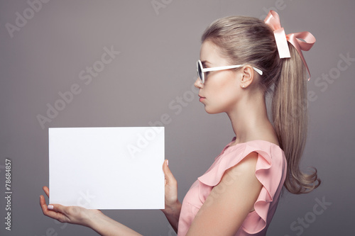 Fashion Woman With Sunglasses Holding Empty Paper Blank In Hands