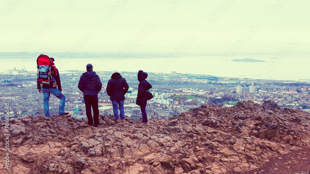 Tourists enjoying view of Edinburgh from top of Arthurs seat