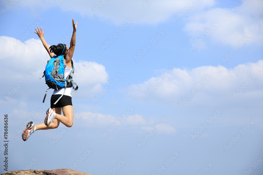 young asian woman hiker jumping mountain peak cliff young asian woman hiker jumping mountain peak cliff