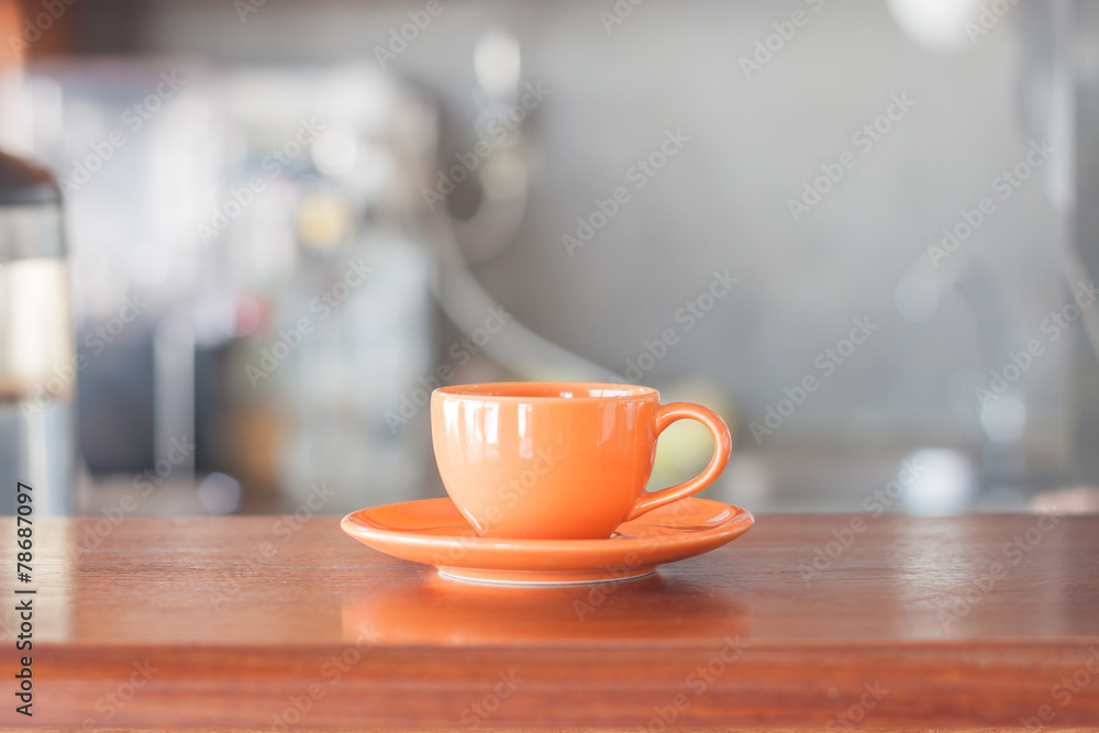 Mini oange coffee cup in coffee shop