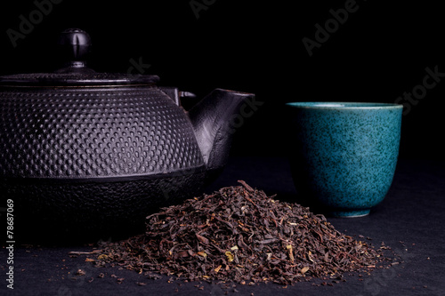 Black Teapot with Healthy Tea Leaves photo