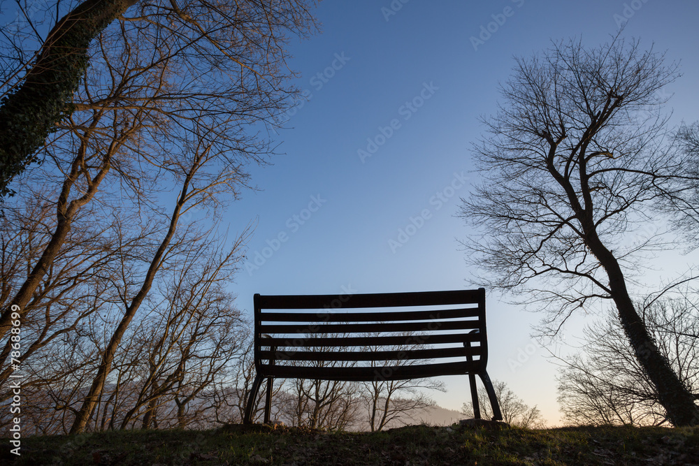 silhouetted park bench in sunset light