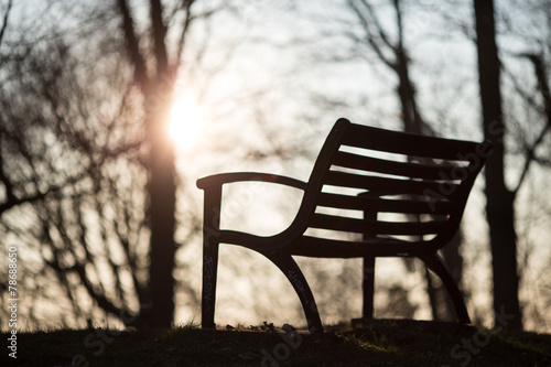 silhouetted park bench in sunset light