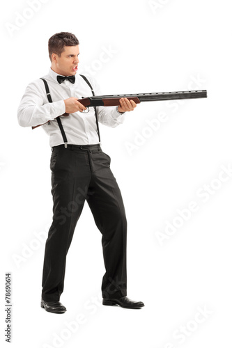 Angry young man shooting at something