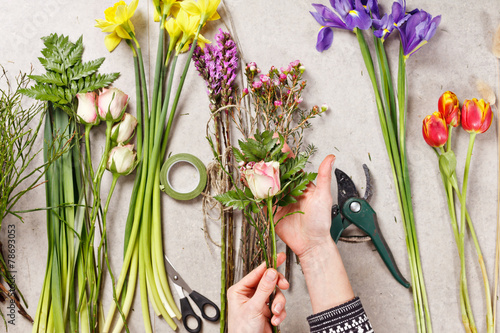 Fototapeta Naklejka Na Ścianę i Meble -  hands of florist making bouquet spring flowers