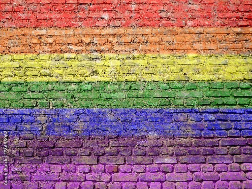 Fototapeta premium Rainbow-flag painted on old wall
