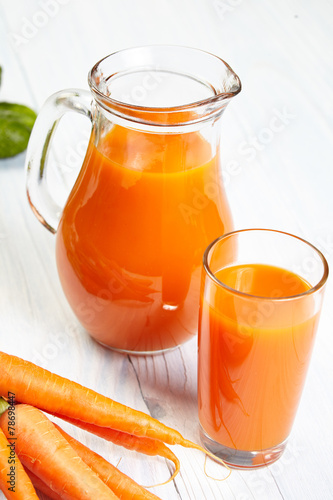 carrot juice on white wood background