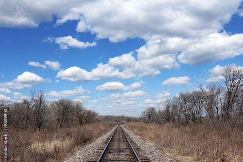 Railway to horizon and clouds on the sky background. © Arrows