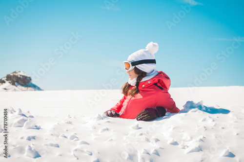 Young woman skier enjoying the snow sunbathing