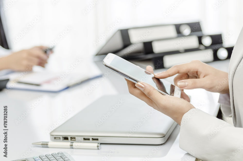 Fototapeta premium Business people using smart phone in office
