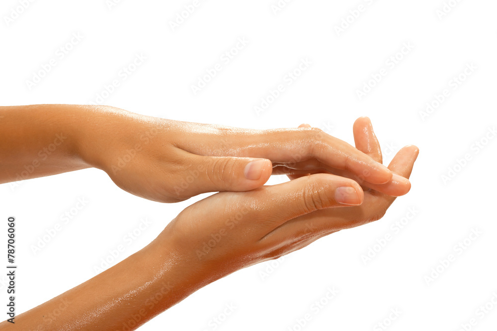Close-up of female hands while applying oil Close-up of female hands while applying oil