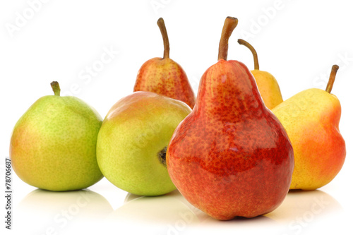 Assortment of different colorful pears on a white background