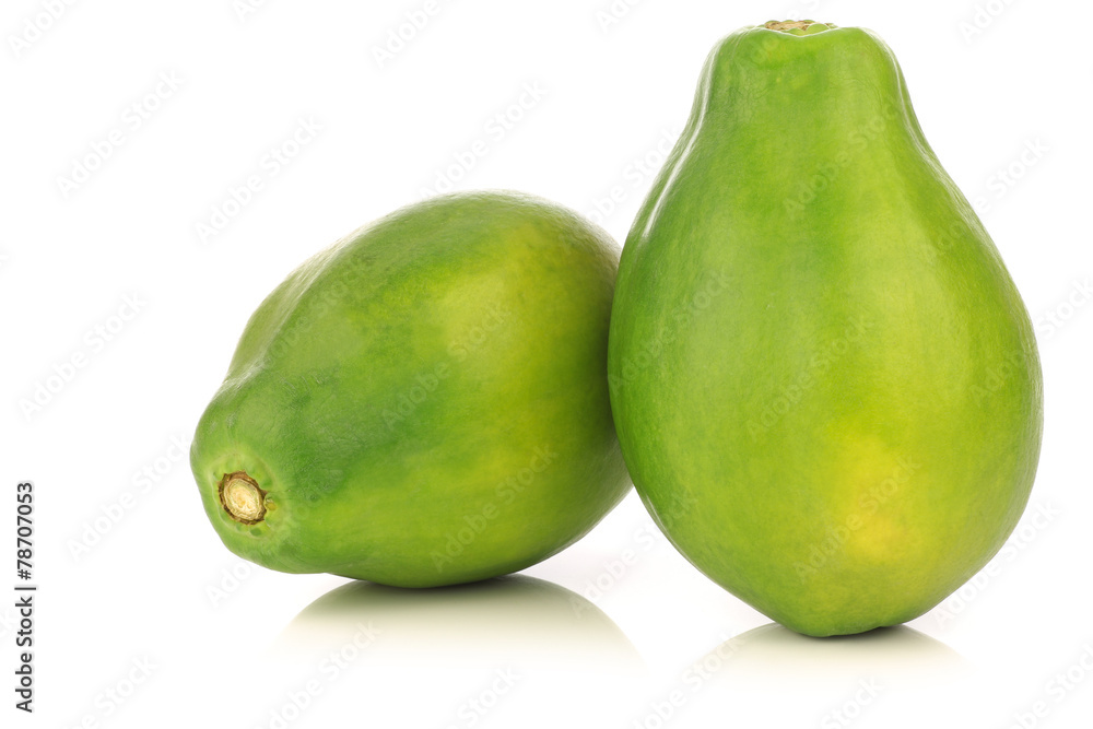 two fresh papaya fruits on a white background two fresh papaya fruits on a white background