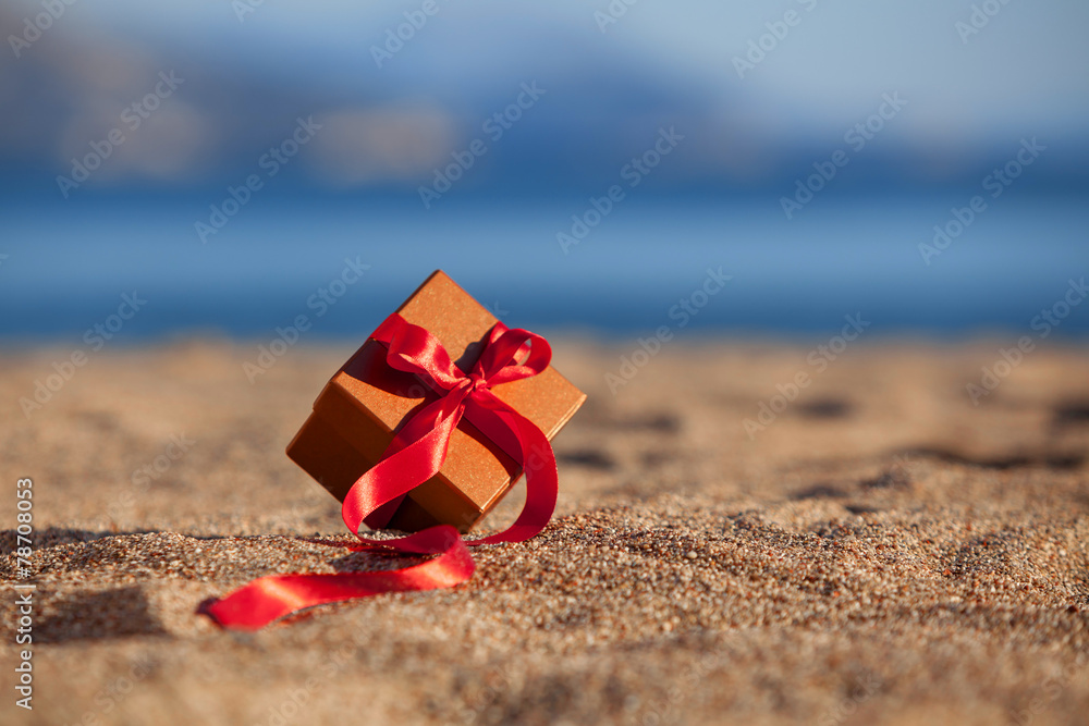 Terracotta color gift box ona beach Terracotta color gift box ona beach