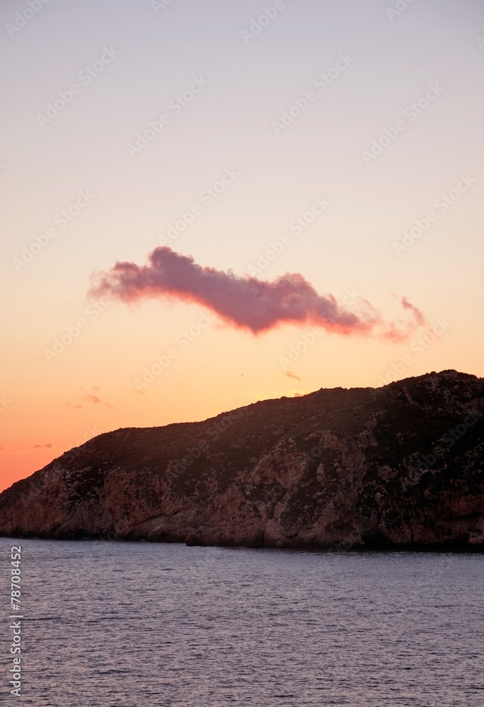 Pink cloud over Mediterranean island, winter. Mallorca, Spain.