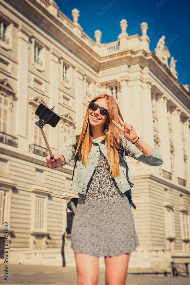 young beautiful tourist girl in Spain taking selfie vintage edit