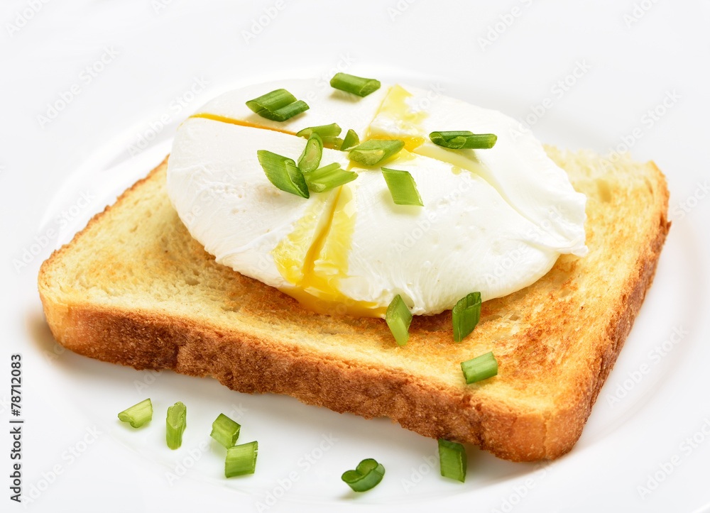 Poached egg on bread over white plat Poached egg on bread over white plat