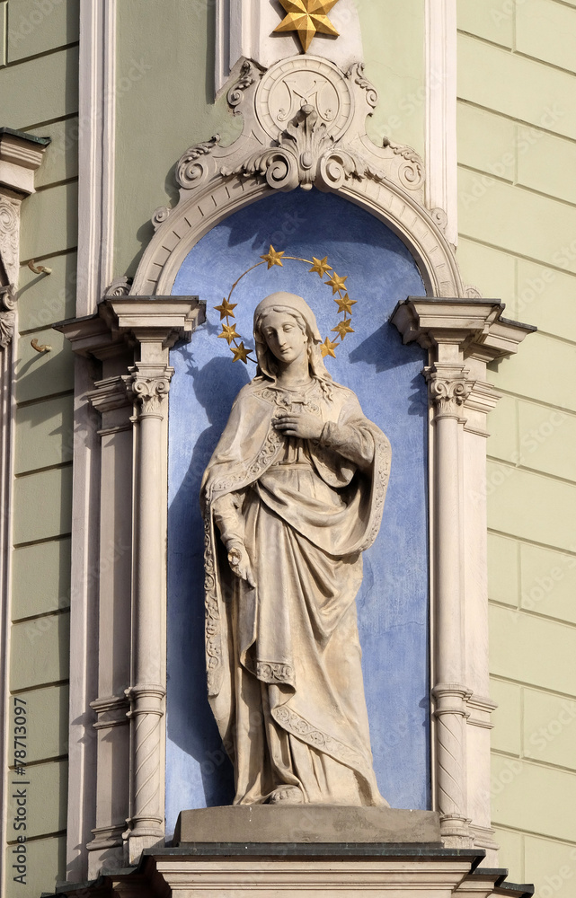 Virgin Mary, statue on the house facade in Graz, Austria Virgin Mary, statue on the house facade in Graz, Austria